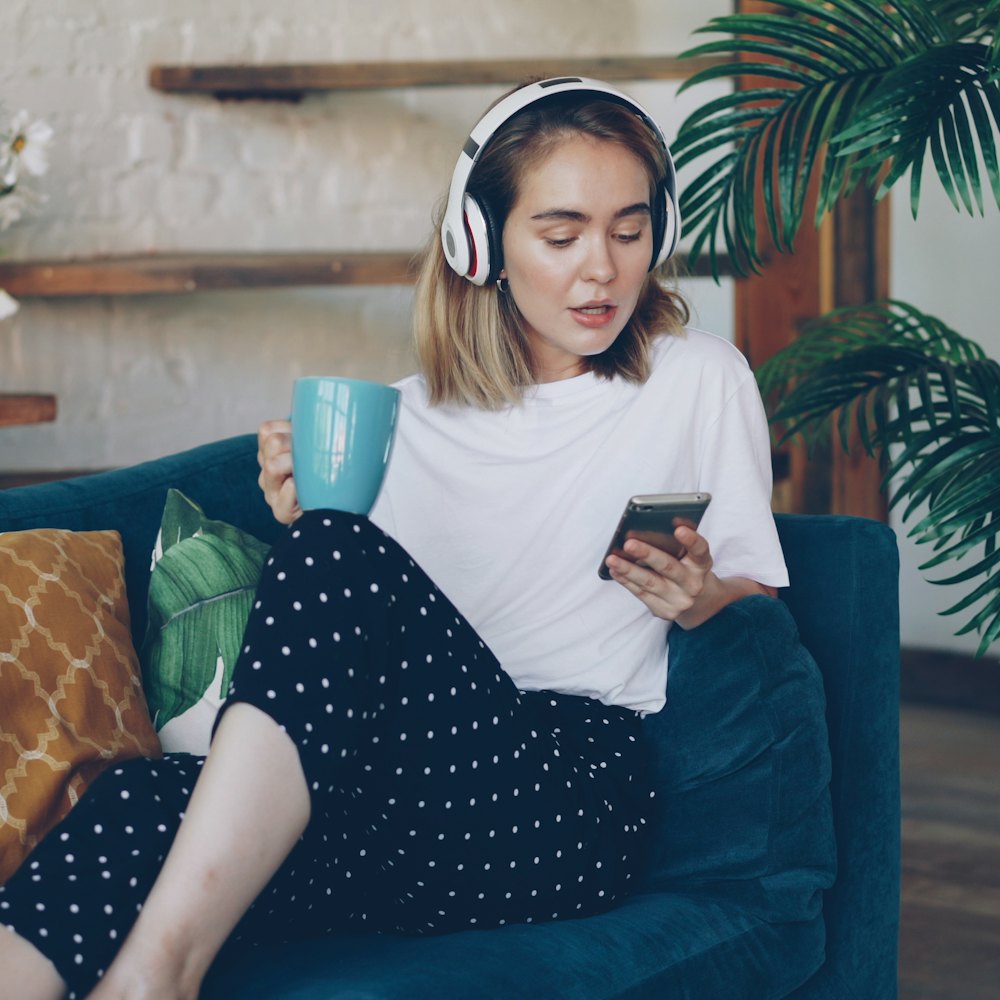 A woman on a sofa checking her phone