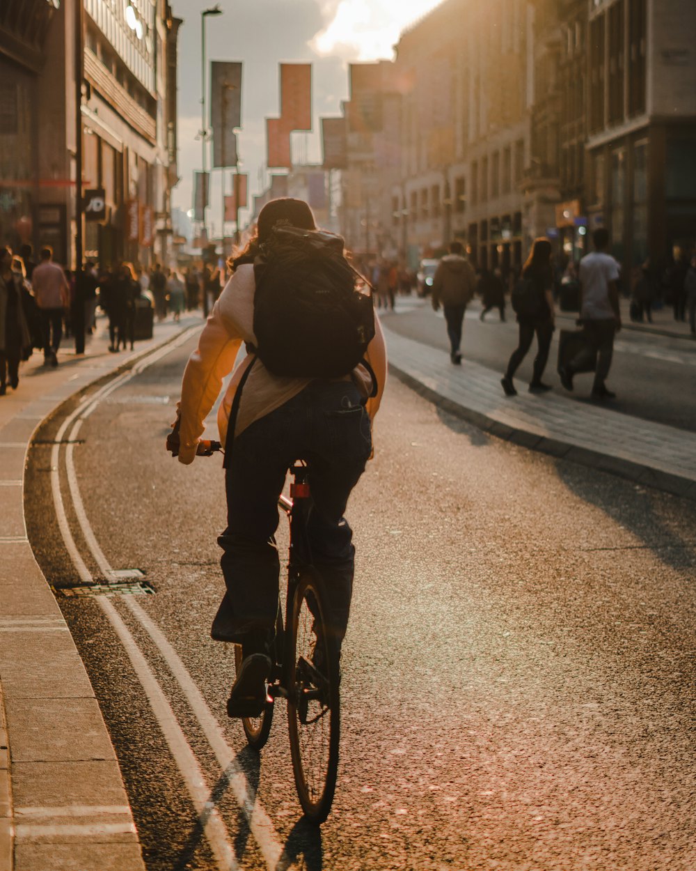 Someone cycling to work down a city street