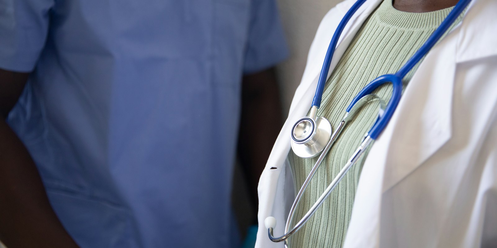 Two clinicians, one with a stethoscope