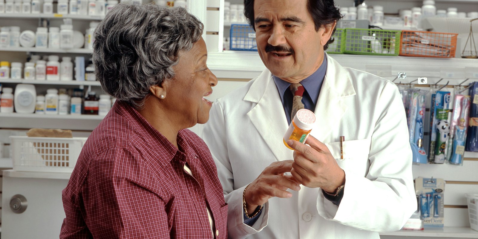A pharmacist talking with a customer in a pharmacy