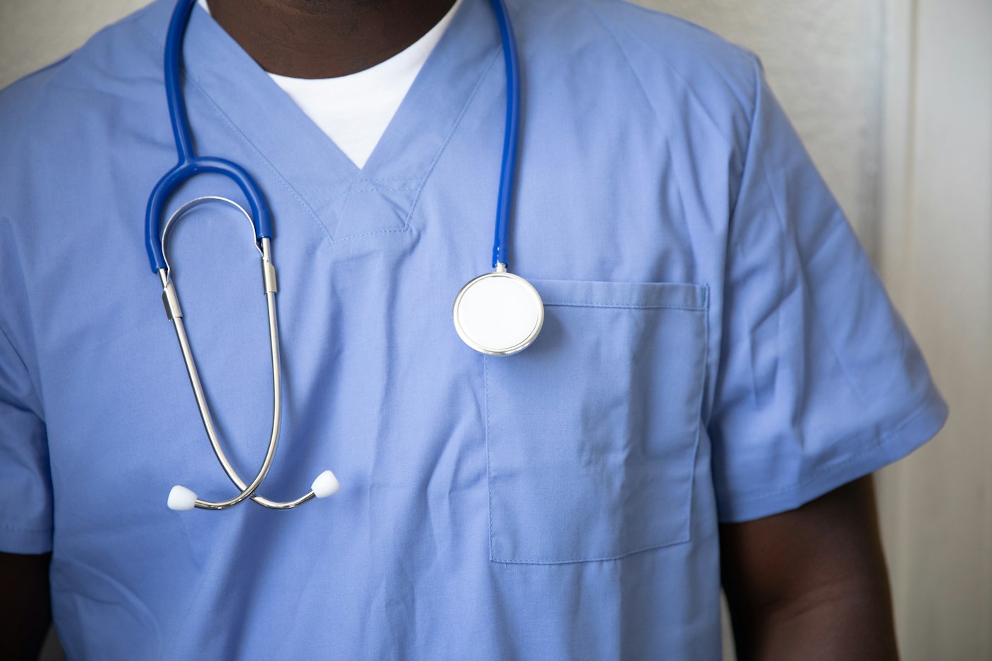 Someone in blue scrubs with a stethoscope